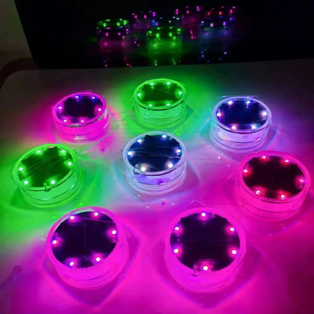 floating solar pool lights, with potted plants