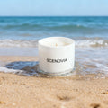 Sea Breeze scented candle, lit candle close-up