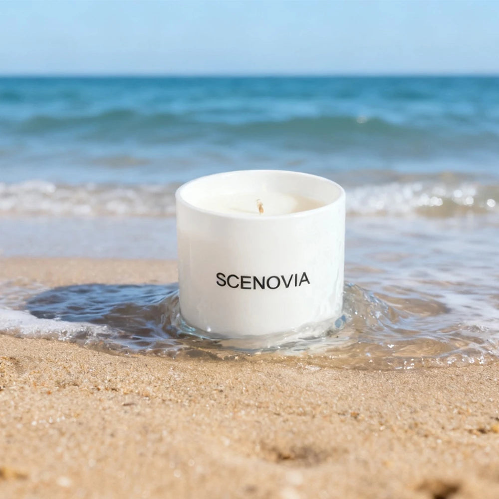 Sea Breeze scented candle, lit candle close-up