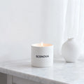 White Waiting scented candle, lit candle close-up