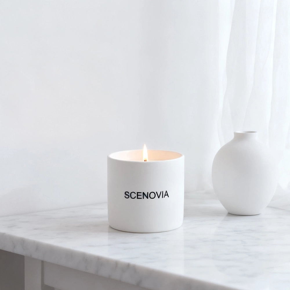 White Waiting scented candle, lit candle close-up